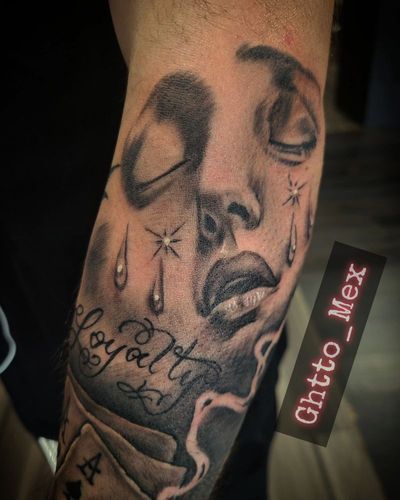 Black and grey forearm piece with a crying woman's face, teardrops and Loyalty script