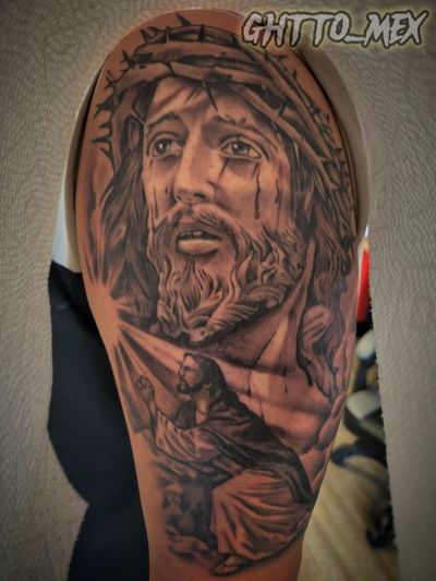 Black and grey Jesus portrait with crown of thorns above a kneeling figure praying in light rays