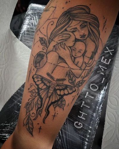 Fine line tattoo of a mother holding a baby above a moth and leaves on the calf